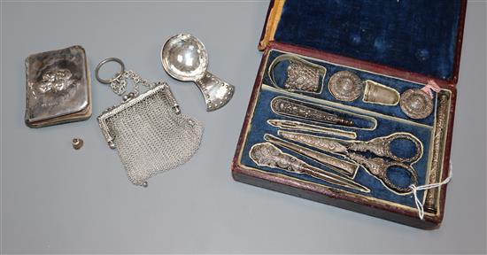 A filigree white metal-mounted sewing necessaire in fitted case and three other items,